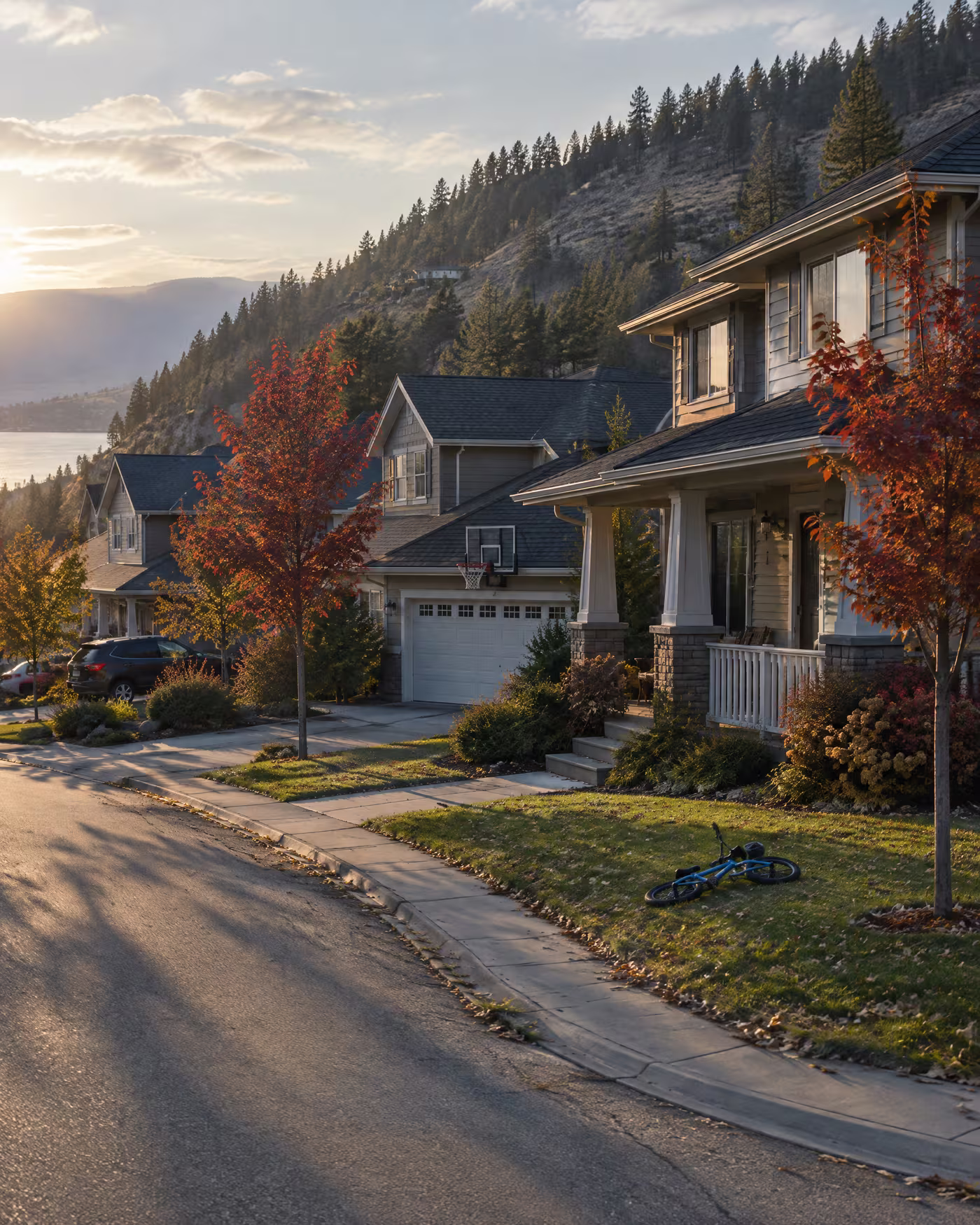 Family houses with front porches on a Kettle Valley crescent in autumn