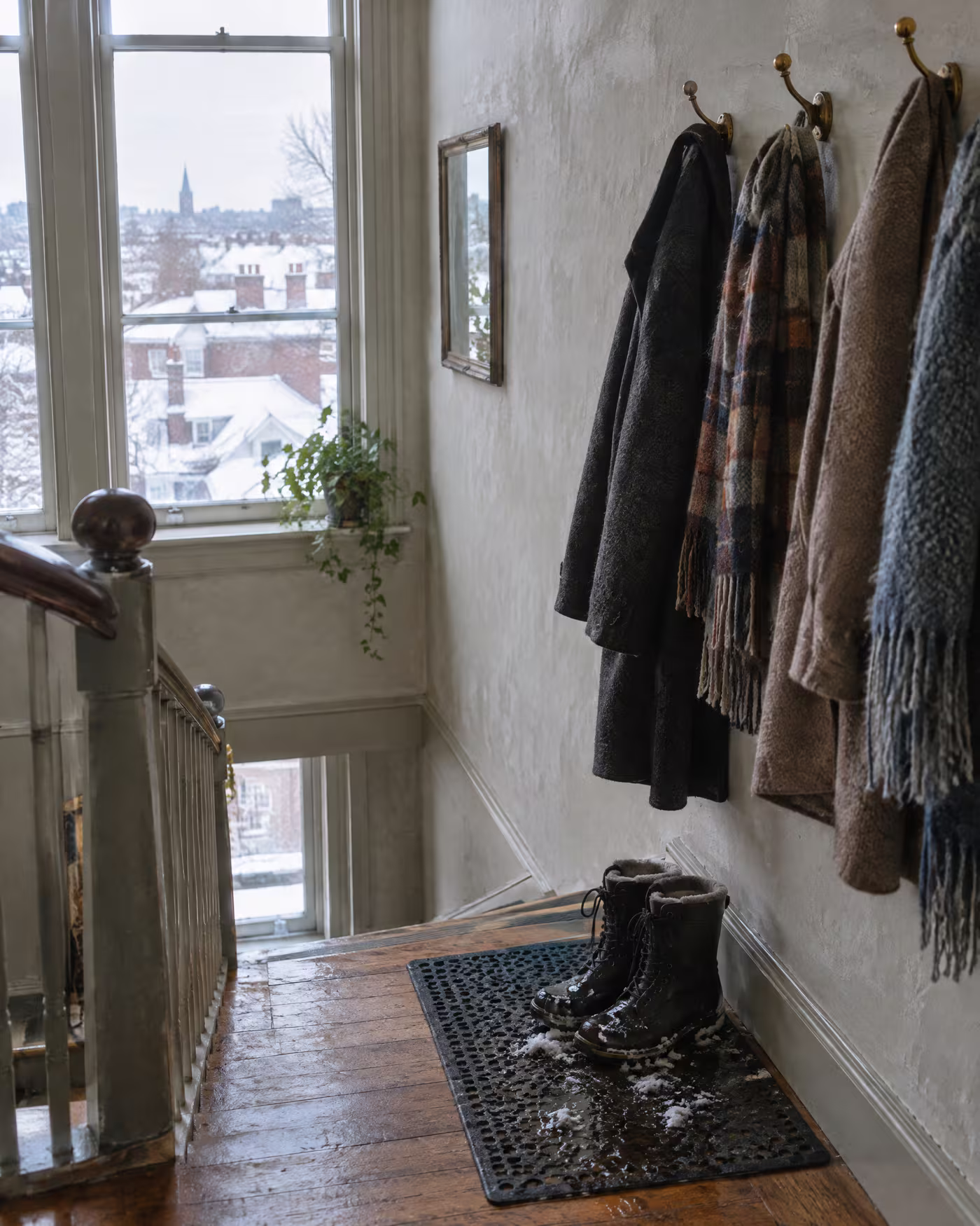 Wet winter boots and wool coats at the top of the studio staircase